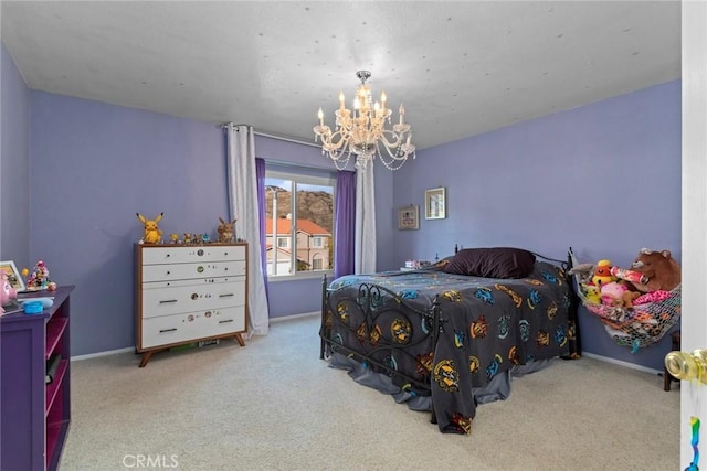 bedroom with carpet, baseboards, and a chandelier