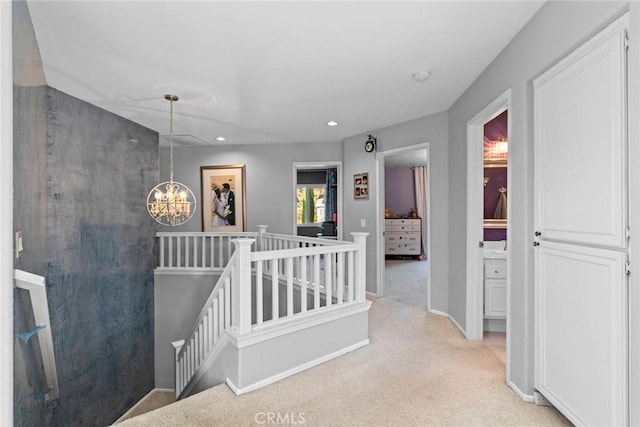 corridor with baseboards, recessed lighting, a notable chandelier, an upstairs landing, and light colored carpet