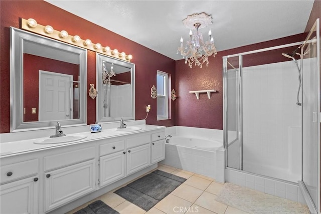 full bath featuring a sink, double vanity, a shower stall, and tile patterned flooring