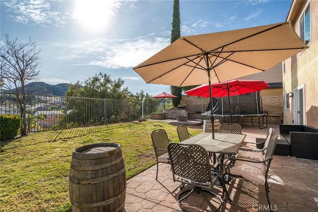 view of patio featuring a mountain view and a trampoline