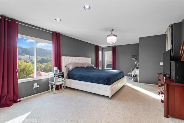 bedroom with recessed lighting, a mountain view, and light colored carpet