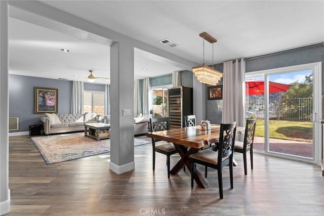 dining space featuring a wealth of natural light, visible vents, baseboards, and wood finished floors