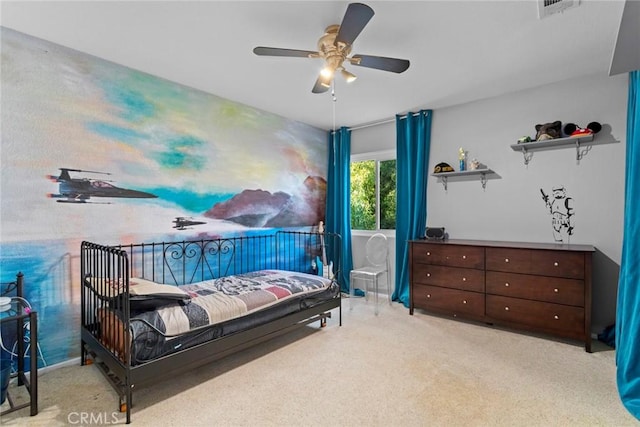 carpeted bedroom featuring a ceiling fan and visible vents