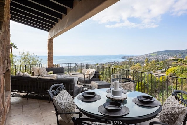 balcony with a water view and outdoor lounge area