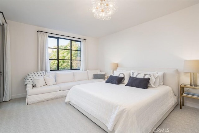 bedroom featuring an inviting chandelier and carpet floors
