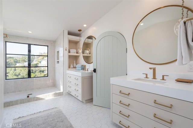 bathroom featuring vanity, tile patterned floors, and walk in shower