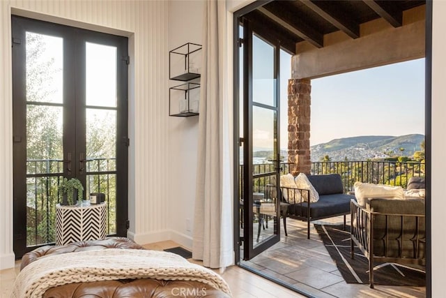 entryway featuring a mountain view and beam ceiling