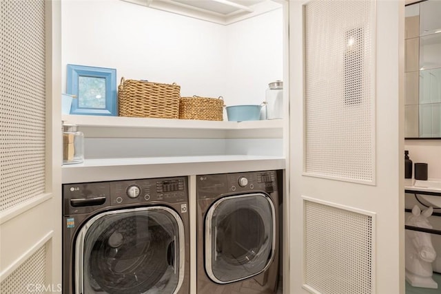 laundry room with washing machine and clothes dryer