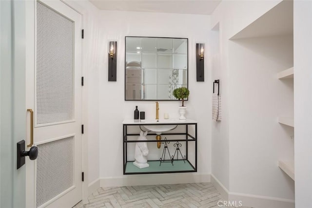 hallway featuring light parquet flooring and sink