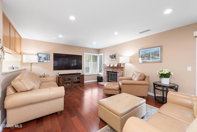 living room featuring a fireplace and dark hardwood / wood-style floors