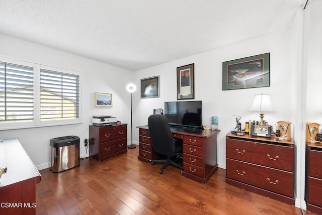 office space with dark wood-type flooring and a textured ceiling