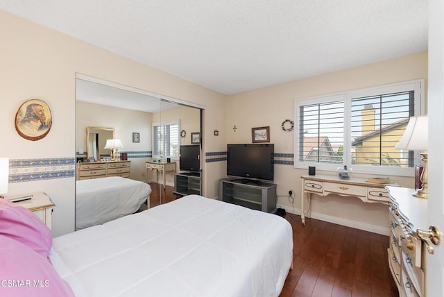 bedroom featuring a closet and dark hardwood / wood-style floors