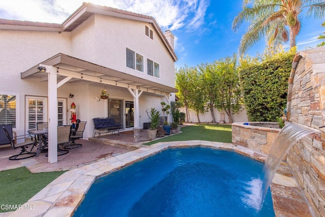 view of pool featuring a patio, pool water feature, and a pergola