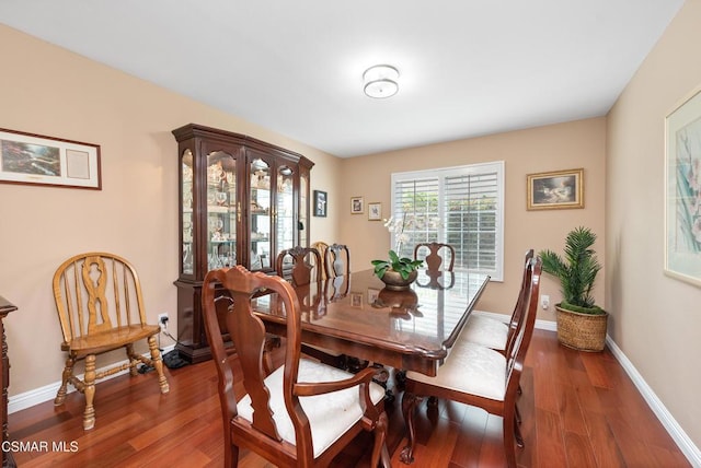 dining space with dark hardwood / wood-style floors