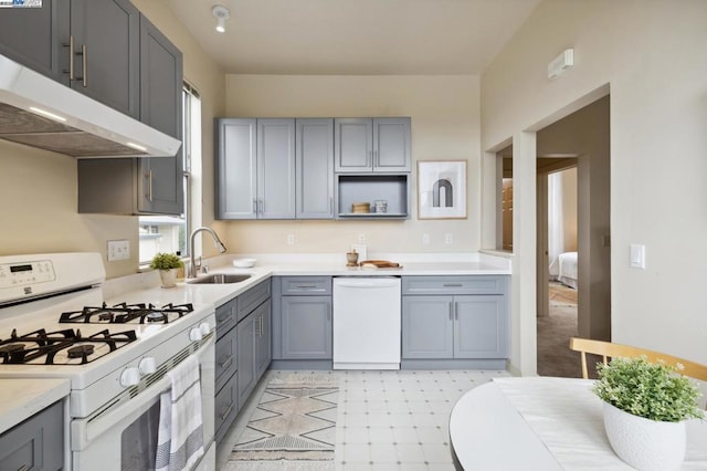 kitchen featuring white appliances, a wealth of natural light, sink, and gray cabinetry