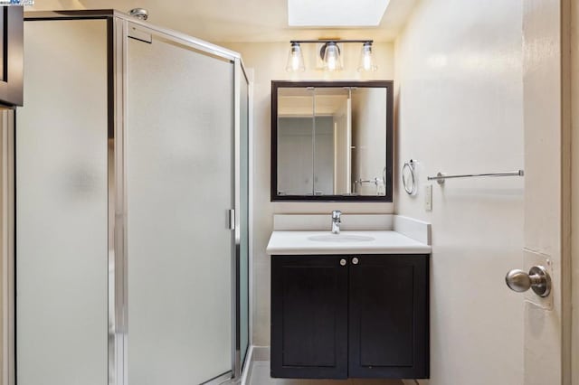 bathroom with vanity and a shower with shower door