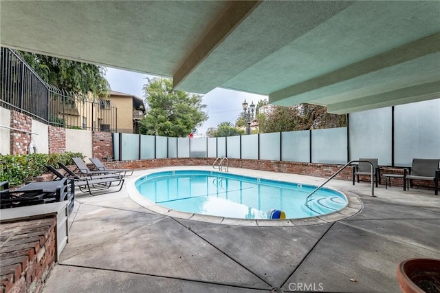 view of swimming pool with a patio area