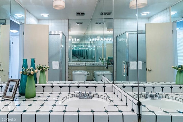 bathroom with vanity, a shower with shower door, and toilet