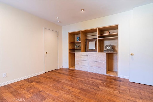 unfurnished bedroom with wood-type flooring and a closet