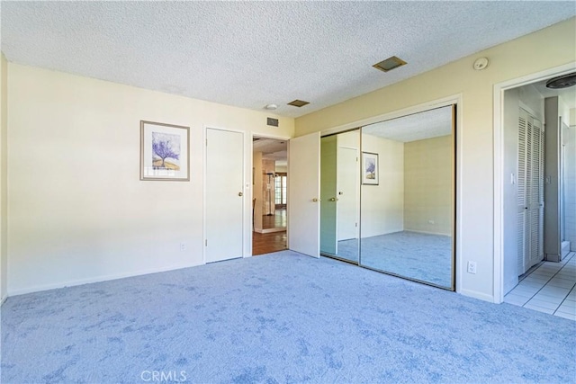 2260 N Cahuenga Blvd Unit 507, Los Angeles, CA 90068 - unfurnished bedroom featuring carpet flooring, a textured ceiling, and a closet