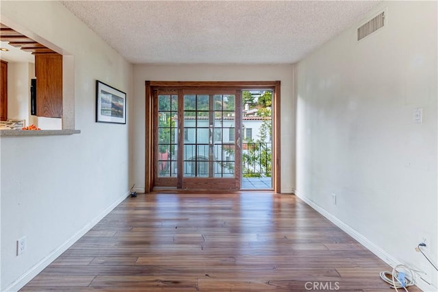 2260 N Cahuenga Blvd Unit 507, Los Angeles, CA 90068 - empty room with a textured ceiling and wood finished floors
