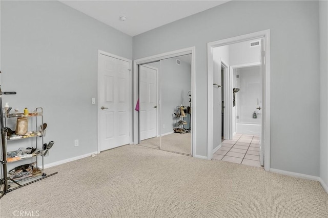 carpeted bedroom with connected bathroom and a closet