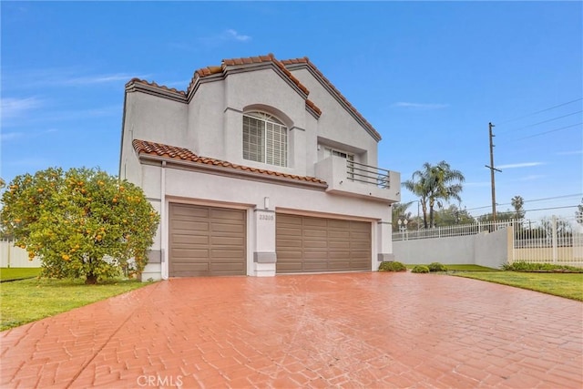 mediterranean / spanish-style home featuring a garage, a balcony, and a front yard