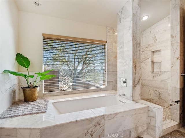 bathroom with tiled tub