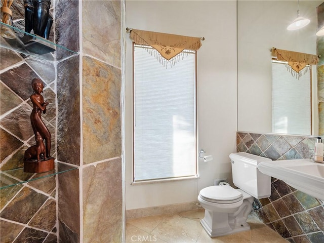 bathroom with toilet and tile patterned flooring