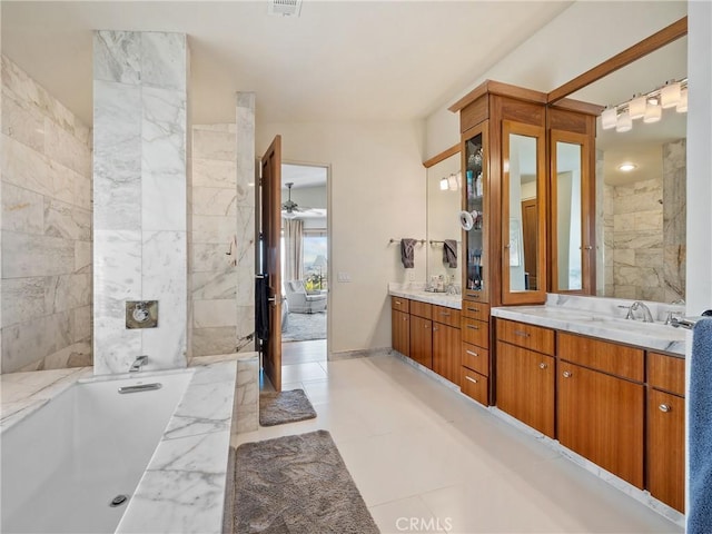 bathroom with vanity, ceiling fan, and a tub to relax in