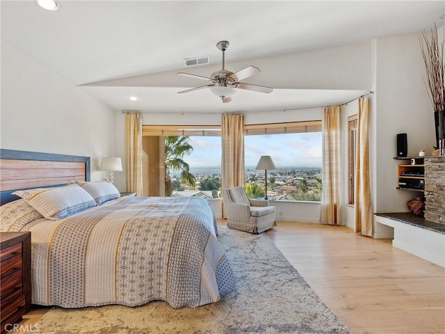 bedroom featuring vaulted ceiling, access to exterior, ceiling fan, and light hardwood / wood-style flooring