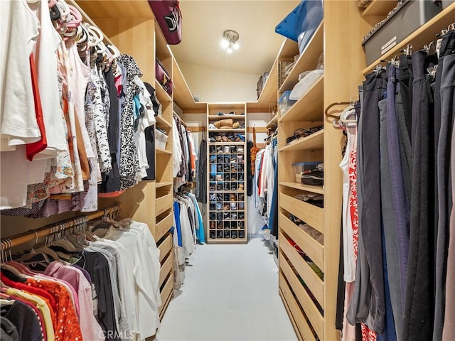 spacious closet featuring vaulted ceiling and tile patterned floors