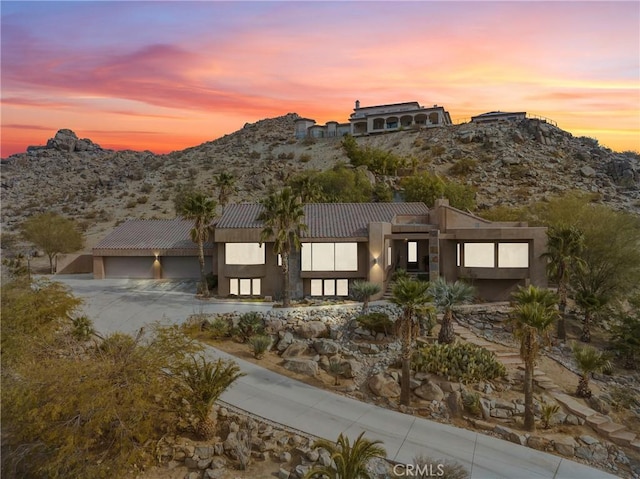 view of front of house with a garage and a mountain view