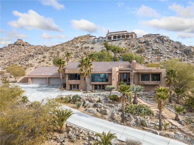 view of front of home featuring a mountain view and a garage