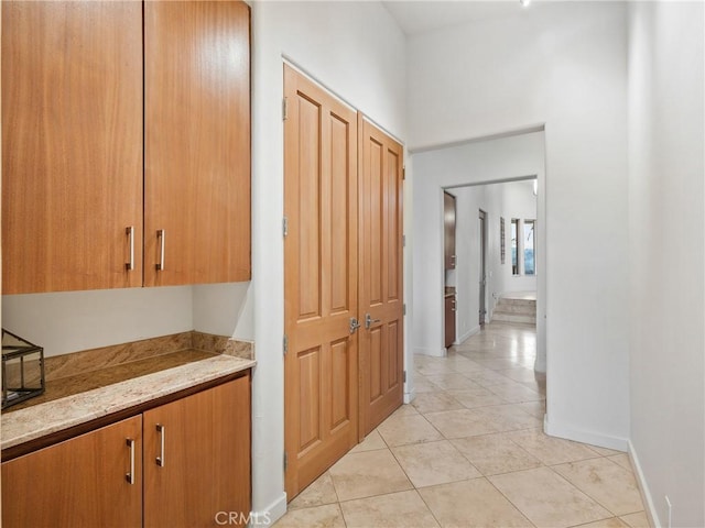 corridor featuring light tile patterned floors