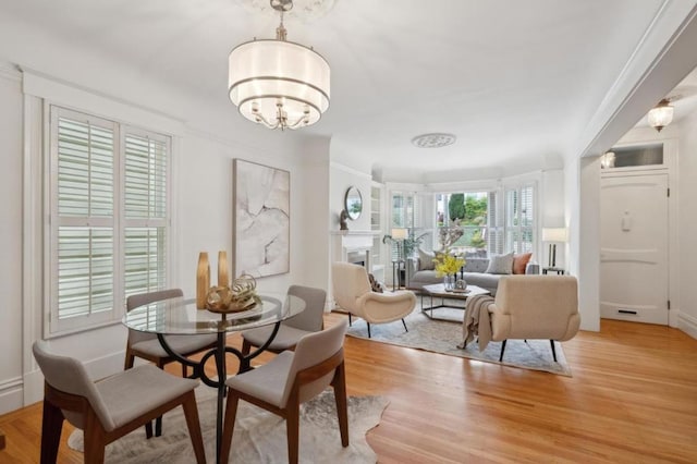 dining room featuring light hardwood / wood-style floors and a notable chandelier