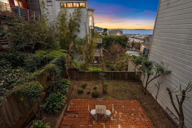 exterior space with a water view and a patio