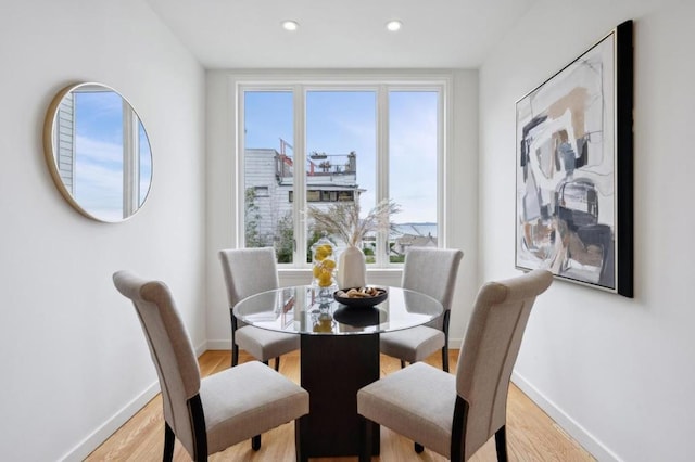 dining space with light hardwood / wood-style floors