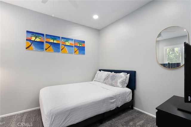 bedroom with dark colored carpet and ceiling fan