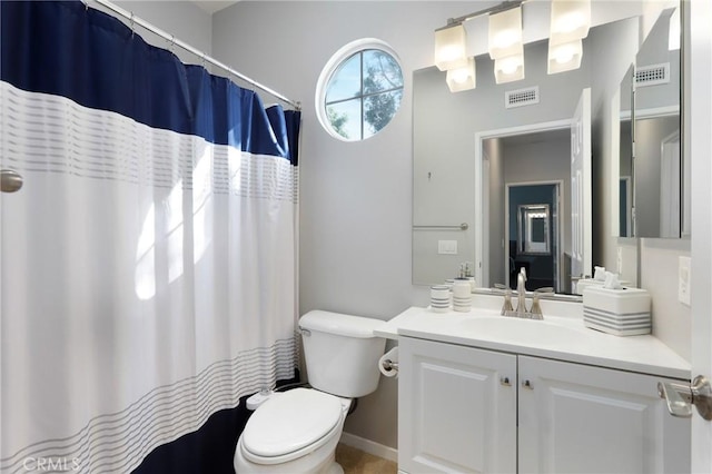 bathroom featuring vanity, curtained shower, and toilet