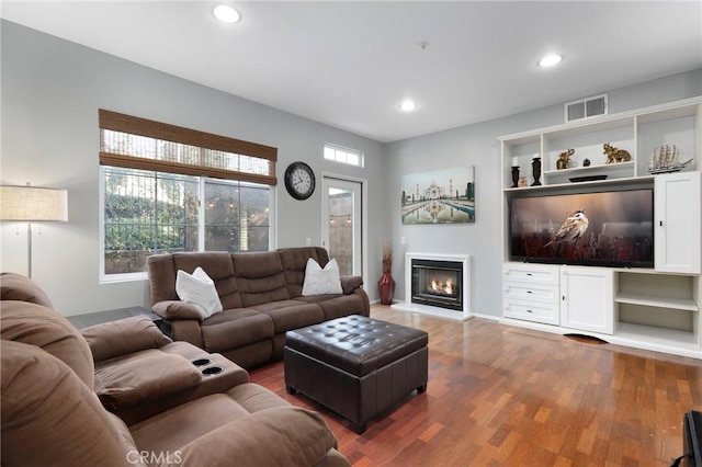 living room featuring plenty of natural light and dark hardwood / wood-style floors