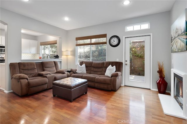 living room featuring sink and light wood-type flooring