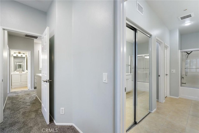 hallway with light tile patterned floors