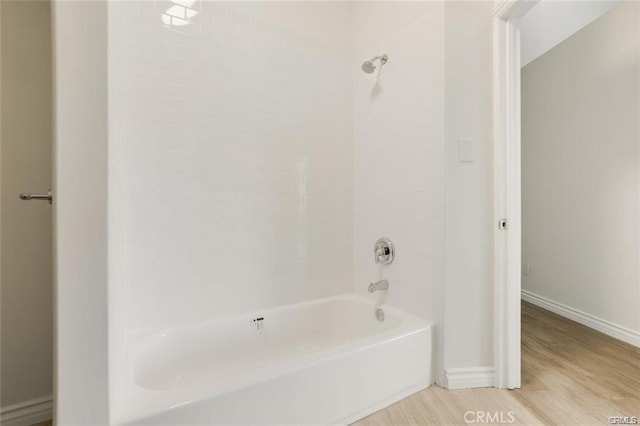 bathroom featuring wood-type flooring and shower / bath combination