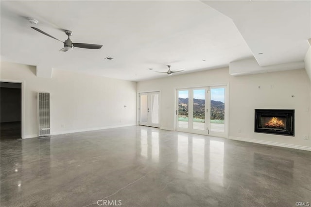 unfurnished living room featuring concrete flooring and ceiling fan