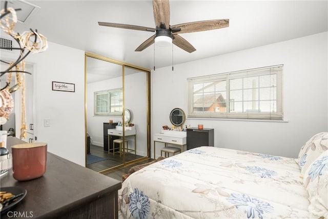 bedroom with ceiling fan, dark hardwood / wood-style flooring, and a closet