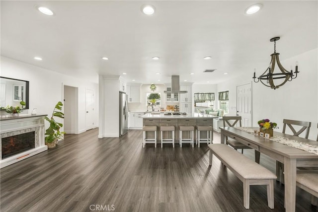 dining room featuring an inviting chandelier and dark hardwood / wood-style flooring