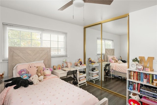 bedroom with ceiling fan, dark hardwood / wood-style flooring, and a closet