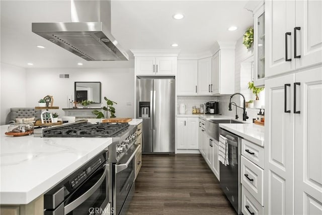 kitchen featuring sink, white cabinetry, island exhaust hood, stainless steel appliances, and light stone countertops