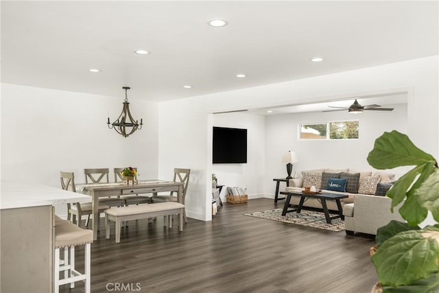 interior space with dark hardwood / wood-style flooring and ceiling fan with notable chandelier